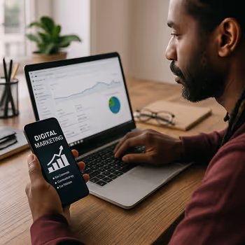A digital marketer at a modern desk with multiple analytics screens, representing a hybrid strategy that blends paid and organic marketing for ethical brand visibility.